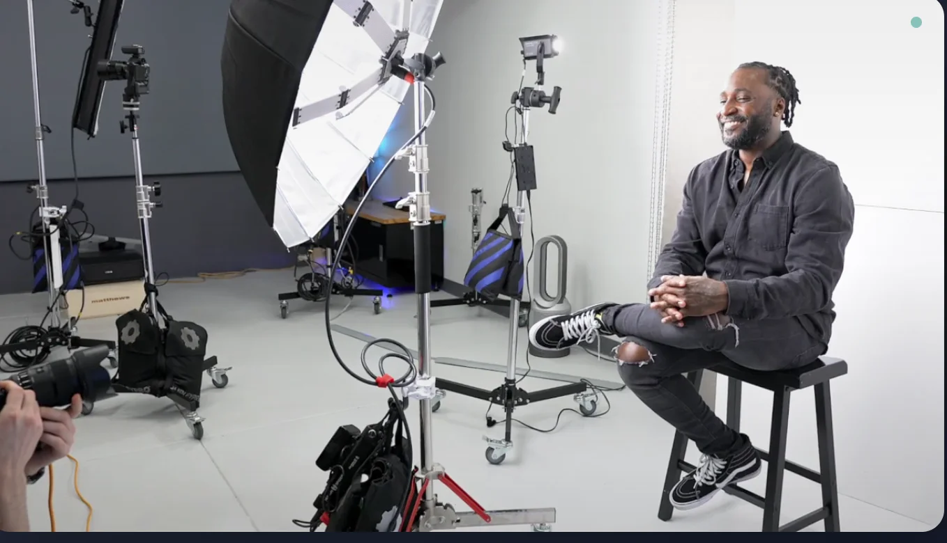 Client relaxing in comfortable Philadelphia headshot photography studio with professional lighting setup